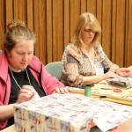 Ashley Meek and Laura Keller wrap gifts Thursday morning. (Evan Pappas/Staff Photo)