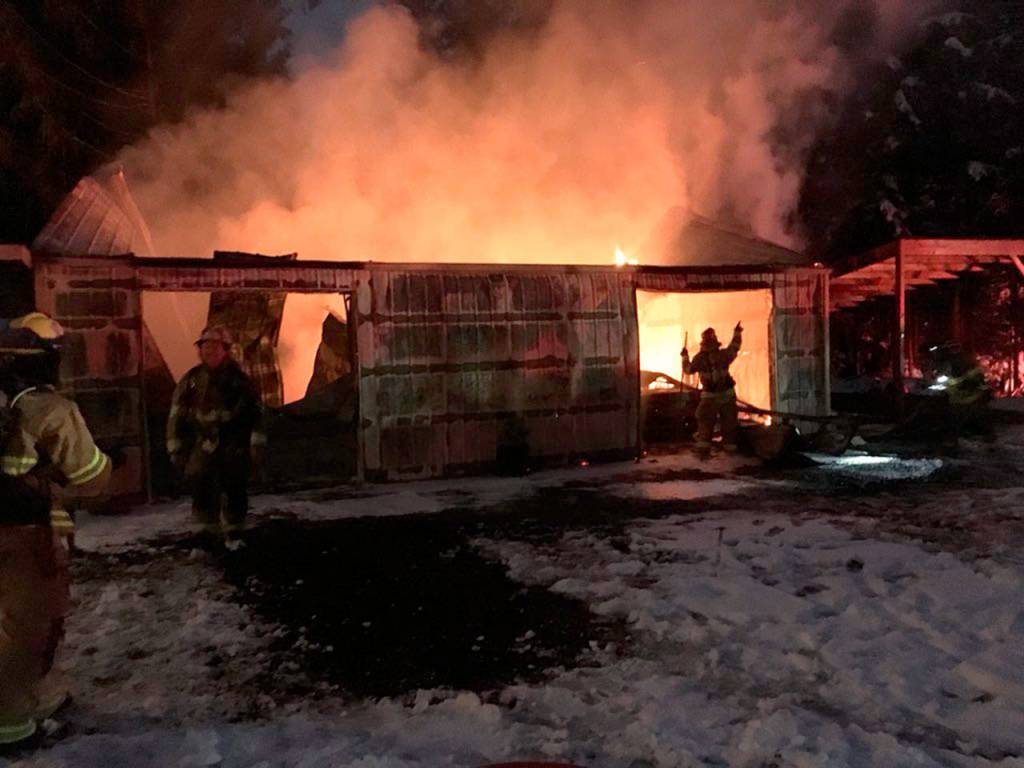 A garage fire on 473rd Avenue SE in North Bend, while firefighters work to extinguish the flames. (Photo courtesy of Eastside Fire and Rescue)