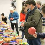 Attendees examine the hand-made bowls and decide which one they want to take home. (Courtesy photo)