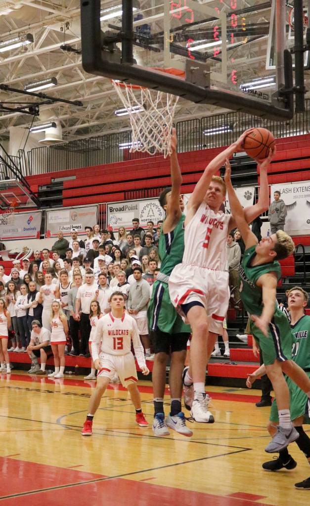 Jabe Mullins tries to take a shot while Woodinville players attempt to stop him. (Evan Pappas/Staff Photo)