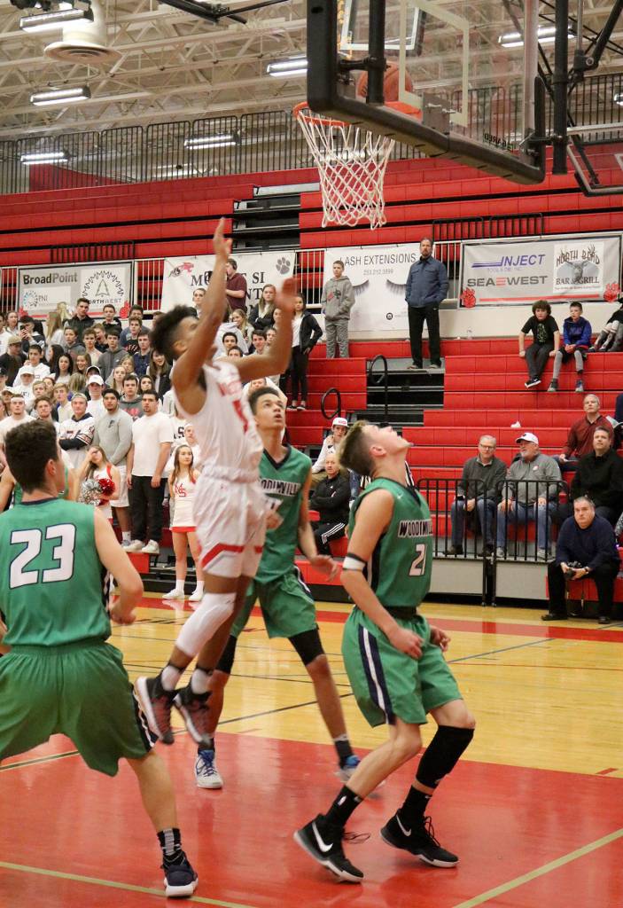 Jesiah Irish taps the ball back into the net after a rebound. (Evan Pappas/Staff Photo)