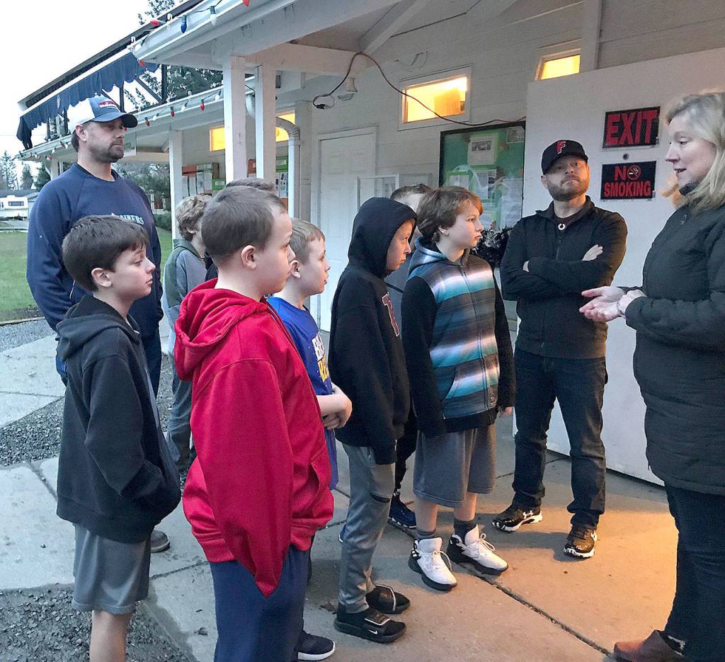 Snoqualmie Valley Food Bank Executive Director Heidi Dukich gives the Wildcat Baseball Club a tour of the food bank and a briefing on who the food bank serves Jan. 8 when the team delivered a donation from its recently completed food drive. (Courtesy Photo)