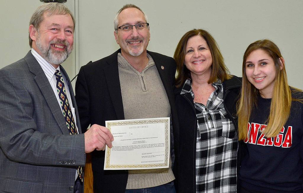 North Bend Mayor Ken Hearing congratulates re-elected City Councilman Alan Gothelf, pictured with his family, on starting another term in city government. (Courtesy Photo)