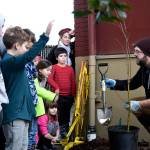 Geoff Bough is swamped with volunteers who want to help dig holes for the new rain garden. (Carol Ladwig/Staff Photo)