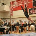 Lindsay Silverman swings to land on the mat as her team cheers her on. (Evan Pappas/Staff Photo)