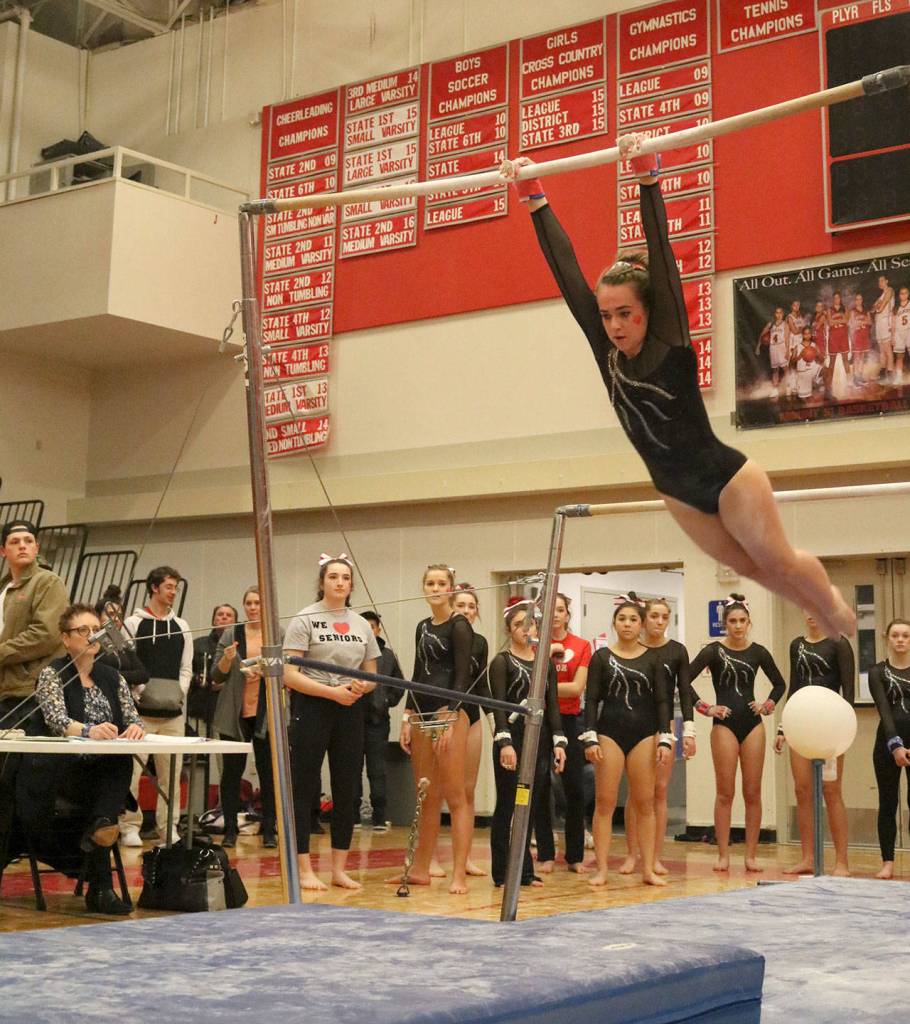Lindsay Silverman swings to land on the mat as her team cheers her on. (Evan Pappas/Staff Photo)