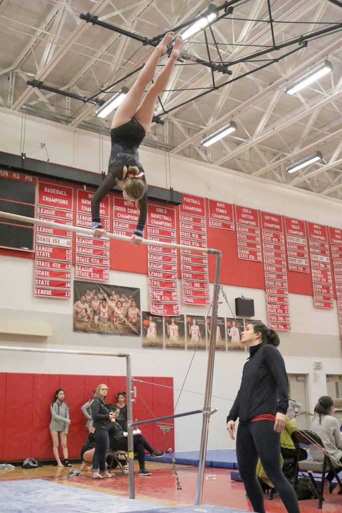 Tylor Zwiefelhofer attempts her new routine at the Eastlake match as coach Kelly Loragner watches from below. (Evan Pappas/Staff Photo)