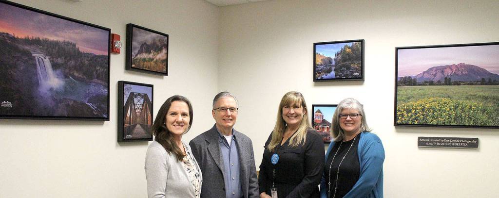 Snoqualmie Elementary staff and parents thanked photographer Don Detrick for his scenic photos, contributed to brighten the school office. Pictured from left are SES Registrar and school secretary Michelle Pearlstein, artist Don Detrick, secretary Shannon Smith and SES PTSA President Kim Jones. (Photo courtesy of Abbey Cantrell)