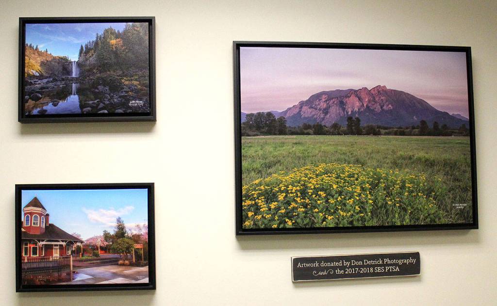 A sampling of Detricks scenic photography decorates the school office wall. (Photo courtesy of Abbey Cantrell)
