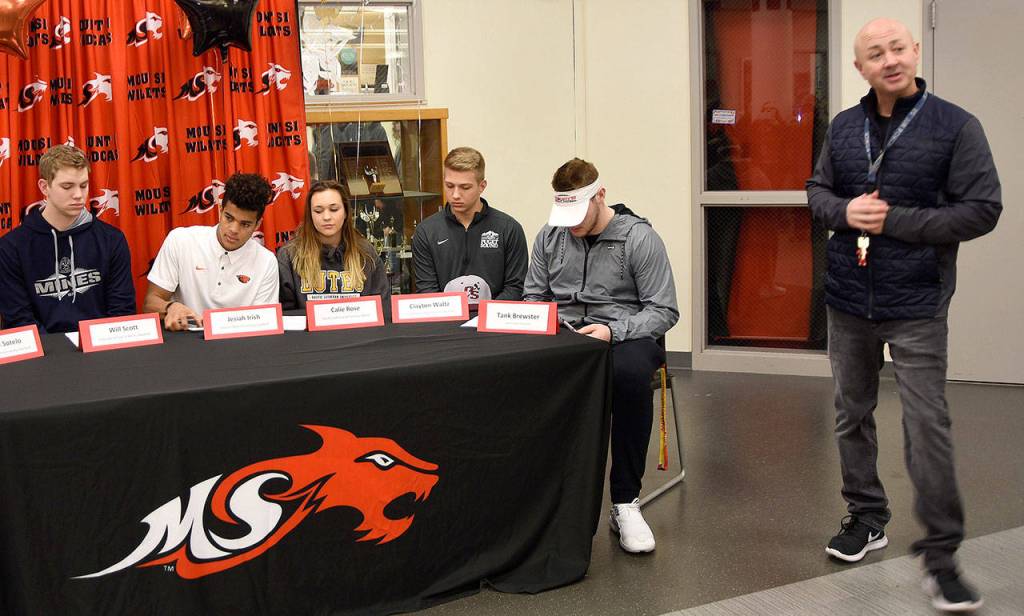 Mount Si Athletic Director Darren Brown welcomed family members to the National Signing Day celebration at the high school Wednesday morning, then introduced the seven athletes signing letters of intent to play college sports. (Carol Ladwig/Staff Photo)