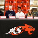 Athletes taking part in National Signing Day at Mount Si High School are, from left: Michael Collins, who will play football at Pomona College, Claremont, Calif.; David Sotelo, who will play football for Western Oregon University; Will Scott, who will play baseball at the Colorado School of Mines; Jesiah Irish, who will play football at Oregon State University; Calie Rose, who will play soccer at Pacific Lutheran University; Clayton Waltz, who will play baseball at the University of Puget Sound; and Tank Brewster who will play football at Simon Fraser University in Burnaby, B.C. (Carol Ladwig/Staff Photo)