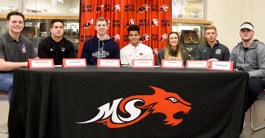 Athletes taking part in National Signing Day at Mount Si High School are, from left: Michael Collins, who will play football at Pomona College, Claremont, Calif.; David Sotelo, who will play football for Western Oregon University; Will Scott, who will play baseball at the Colorado School of Mines; Jesiah Irish, who will play football at Oregon State University; Calie Rose, who will play soccer at Pacific Lutheran University; Clayton Waltz, who will play baseball at the University of Puget Sound; and Tank Brewster who will play football at Simon Fraser University in Burnaby, B.C. (Carol Ladwig/Staff Photo)