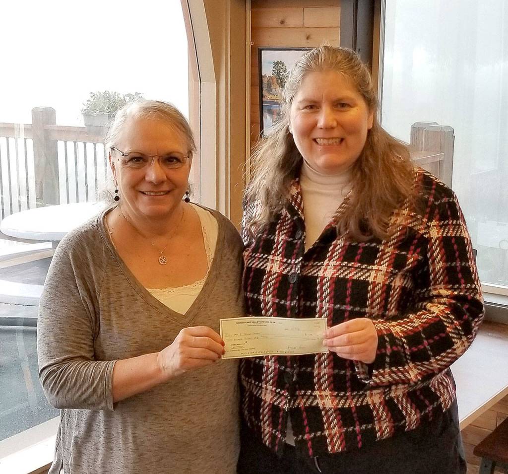 Kiwanis President Marie Jackson presented Mt. Si Senior Center Executive Director Susan Kingsbury-Comeau with a $500 check, the first award in the Kiwanis new community service grant program, Thursday, Feb. 15. (Courtesy Photo)