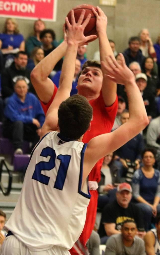 Mount Sis Jack Westover takes a shot over Bothells Jake Medjo. (Andy Nystrom/Staff Photo)