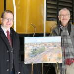 Northwest Railway Museum Executive Director Richard Anderson and artist J. Craig Thorpe unveil the finished artwork of the Interurban car 523 commissioned to promote the restoration of the car. (Evan Pappas/Staff Photo)