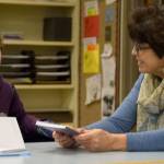 Sitting with her former teacher, first-time author Jay Dilger tells Marianne Bradburn about her work on the book she was donating signed copies of to the Opstad library. (Carol Ladwig/Staff Photo)