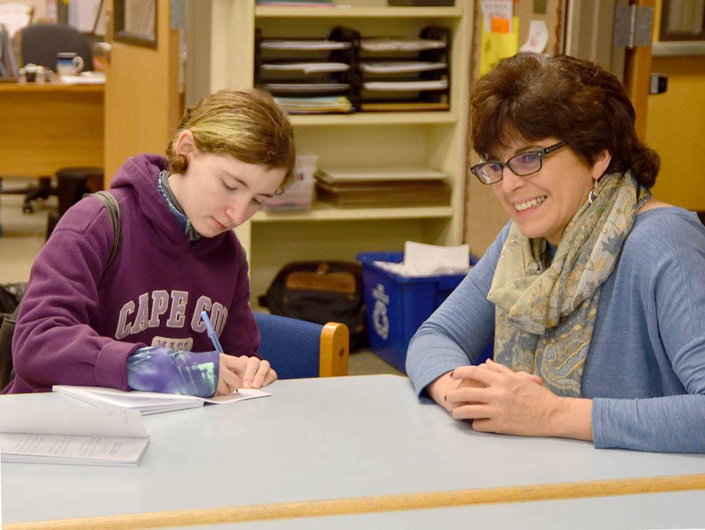 Autographing a copy of her book, Jay Dilger was excited to present her work, hand bound at home, to her teacher Marianne Bradburn, at her former elementary school, Opstad. (Carol Ladwig/Staff Photo)