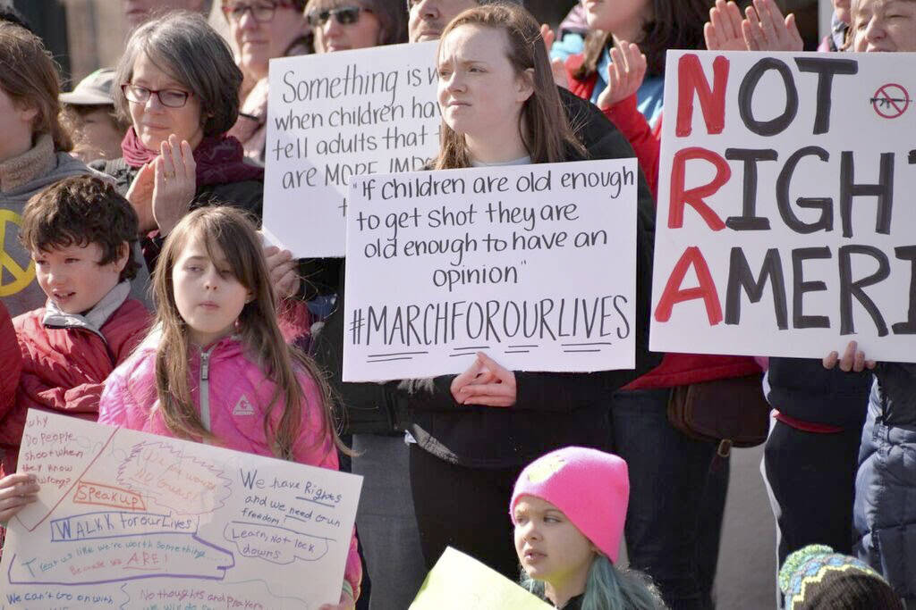 Attendees brought signs to display their messages to drivers through the downtown core. Courtesy photo