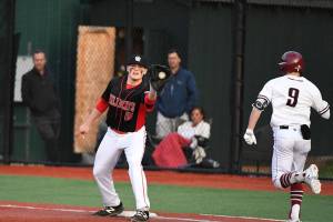Photo courtesy of Calder Productions                                The Mount Si Wildcats defeated the Eastlake Wolves 9-5 in a battle between KingCo 4A teams on April 9. Mount Si improved its overall record to 7-5 with the win. Mount Si first infielder Michael Collins hauls in a toss from the infield, getting Eastlake runner Dalton Chandler out at first base.