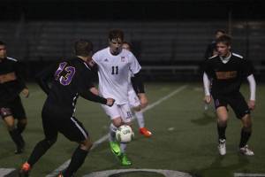 Photo courtesy of Don Borin/Stop Action Photography                                Mount Si Wildcats senior midfielder Kyle Hunter, center, is surrounded by Issaquah Eagles players in a matchup between KingCo 4A rivals on April 13 at Mount Si High School. Issaquah defeated Mount Si 2-0.