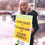 An Alliance for Jobs and Clean Energy representative activist gathers signatures for the Yes on 1631 initiative at the Redmond Library on April 8. Photo courtesy of Alliance for Jobs and Clean Energy Facebook