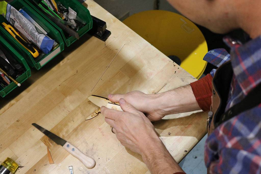 TogetherMade owner Jeb Haber assembles a wooden pocket knife kit which he manufactures out of his shop near Fall City. Aaron Kunkler/Staff photo