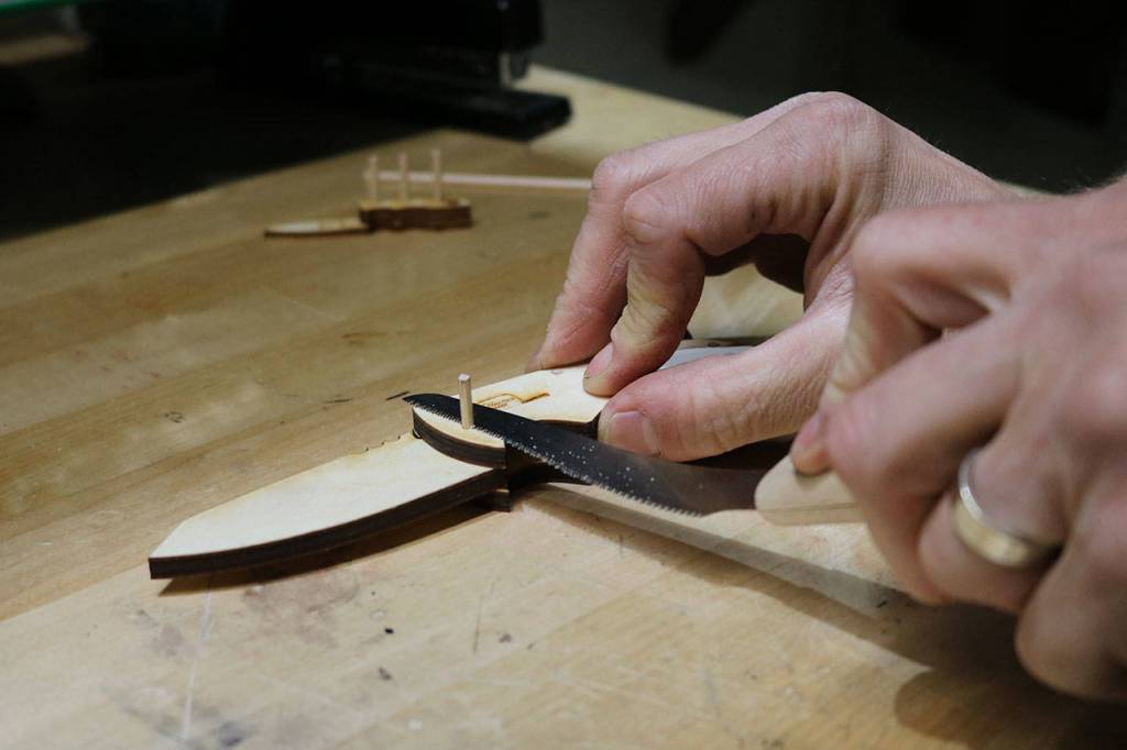 Wooden pegs are cut down to sit flush with the exterior of a wooden pocket knife by TogetherMade owner Jeb Haber. Aaron Kunkler/Staff photo