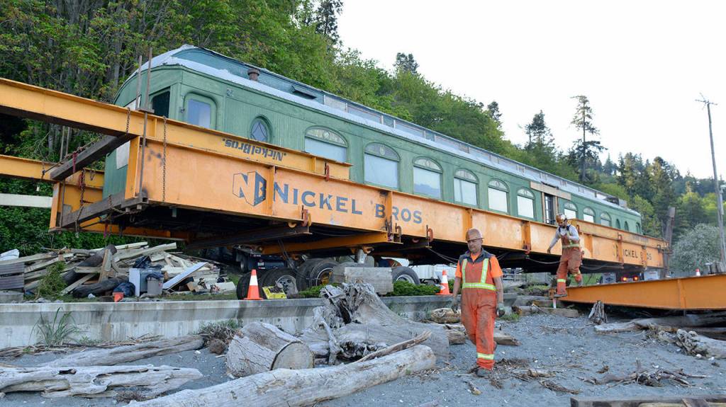 Nickel Bros workers move the parlor car from its shelter to the ship which will carry it across the water. Courtesy Photo