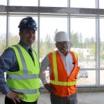 Assistant Superintendent Ryan Stokes and Project Manager Clint Marsh, discuss the pace of the project in one of the student gathering areas that has had the windows installed. Evan Pappas/Staff Photo
