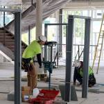 Construction crews work on door frames on the second floor of the building. Evan Pappas/Staff Photo
