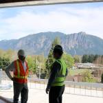 Marsh and Stokes talk by an open wall with a view of Mount Si in the background. Evan Pappas/Staff Photo