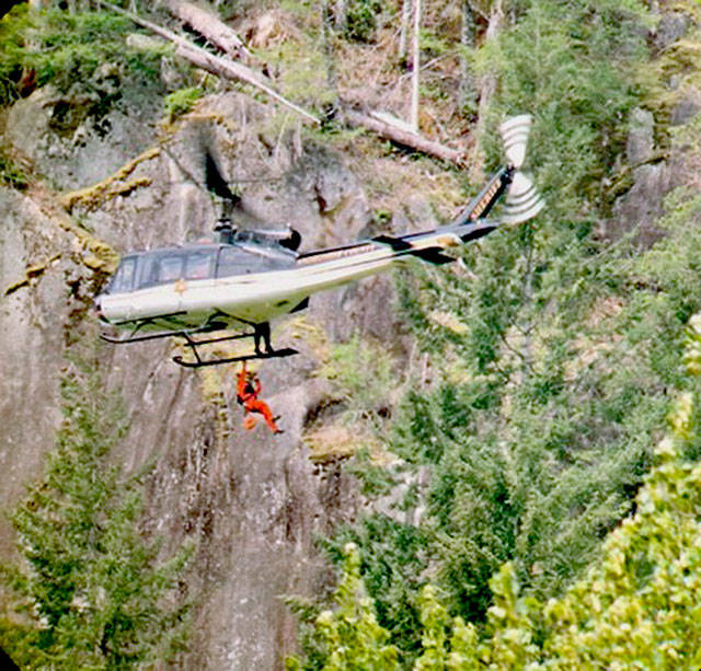 The SnoHAWK10 helicopter of the Snohomish County Sheriffs Office on Saturday lowered a rescue technician and flight medic to treat a man who fell while climbing the Index Town Wall. (Snohomish County Sheriffs Office)