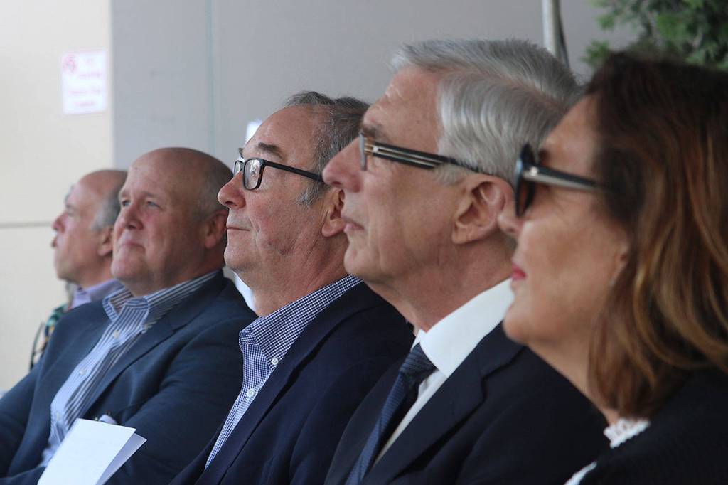 Overlake CEO J. Michael Marsh, center left, Bellevue mayor John Chelminiak, center, and FutureCare Campaign chair York Harris, center left, sit in the front row during a May 9 groundbreaking ceremony at Overlake Medical Center in Bellevue. Aaron Kunkler/Staff photo