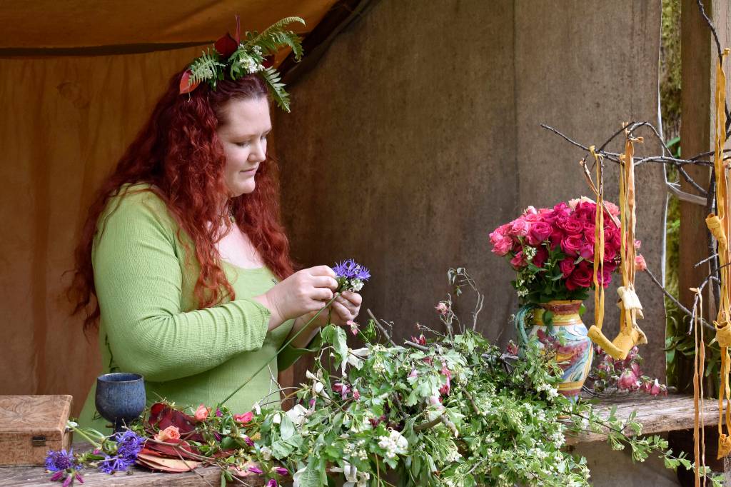 A woman makes and sells flower crowns ($12) in addition to selling hand-made leather pouches and sacks ranging in size and price. Raechel Dawson/staff photo