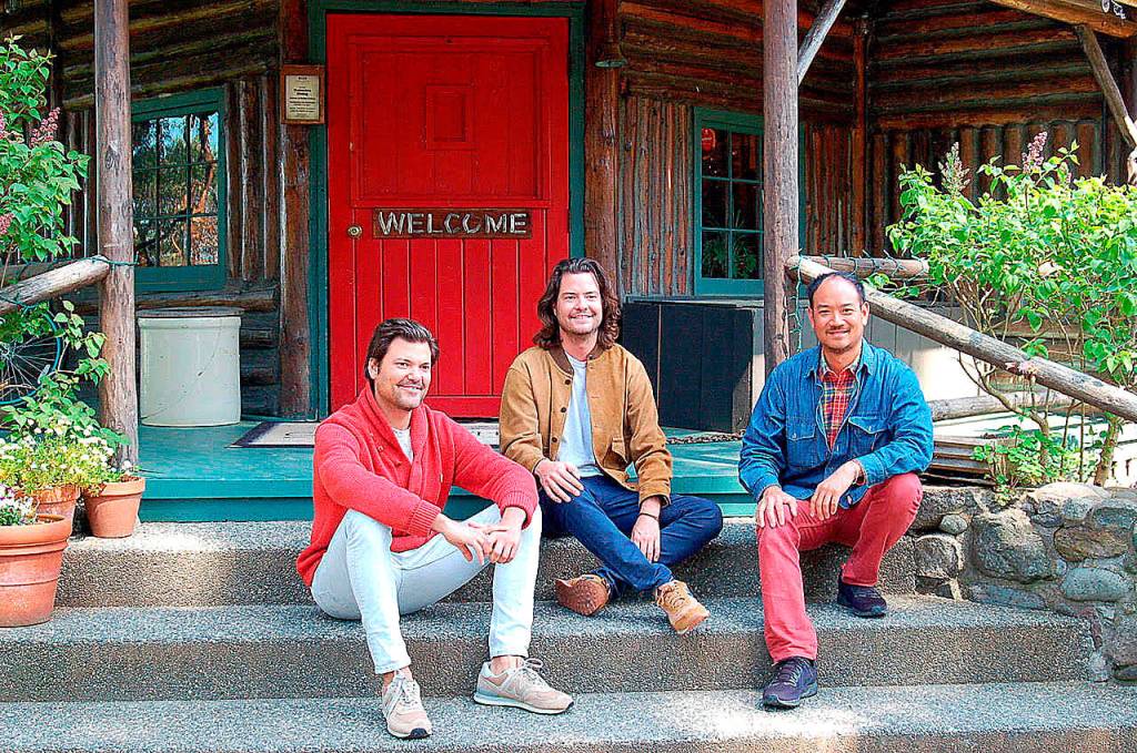 New owners of Central Whidbeys historic Captain Whidbey Inn are, from left, Matt French, his brother, Mike, and Eric Cheong. The three take a break on the inns porch. (Photo by Rick Chapman)