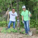 Haru and Joshua Morisawa clean up an area by a tree at Stillwater Bog. Evan Pappas/Staff Photo