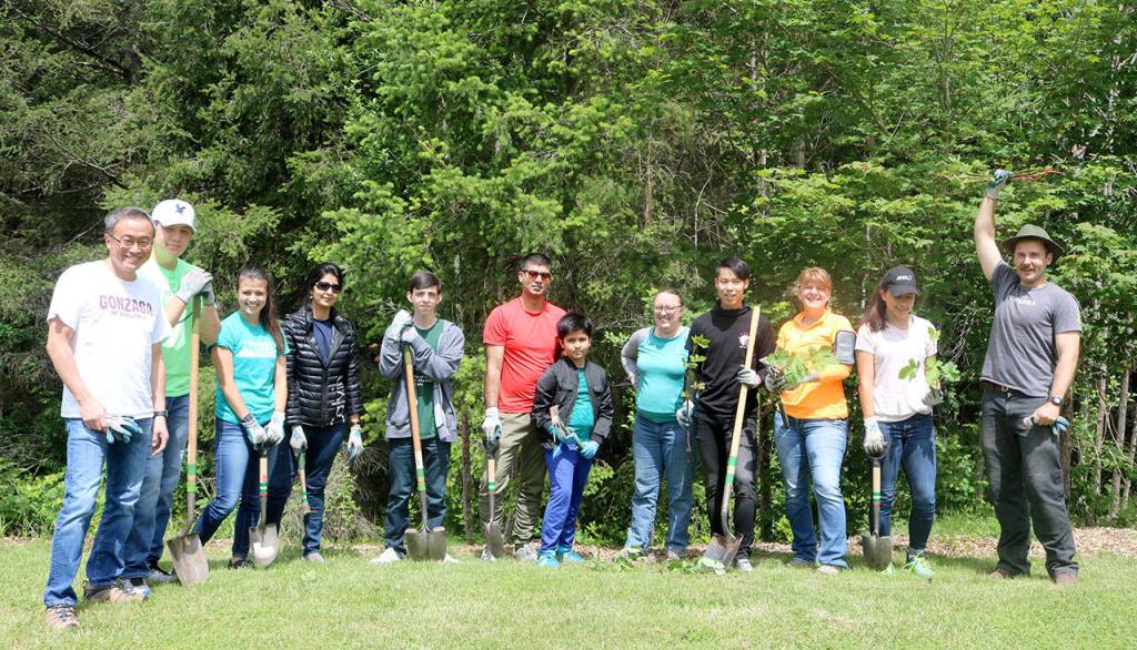 The group of volunteers helping remove invasive plants from Stillwater Bog. From left: Haru Morisawa, Joshua Morisawa, Snoqualmie YMCA Membership Supervisor Emily Morisawa, Manika Dhiman, Connor OBrien, Gaurav Dhiman, Madhav Dhiman, Amanda Reeck, Robert Jiang, Stacey Morisawa, Ana Morisawa, and Forterra Stewardship Coordinator Charlie Vogelheim. Evan Pappas/Staff Photo