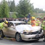 An Eastside Fire and Rescue firefighter uses the jaws of life hydraulic rescue tool to take the roof off of the car and rescue the people inside. Evan Pappas/Staff Photo