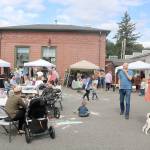People fill the parking lot next to Heirloom Cookshop on the corner of SE River Street and Railroad Avenue. Evan Pappas/Staff Photo