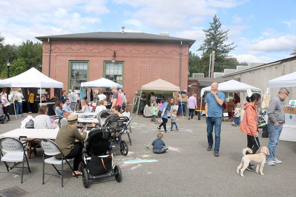 People fill the parking lot next to Heirloom Cookshop on the corner of SE River Street and Railroad Avenue. Evan Pappas/Staff Photo