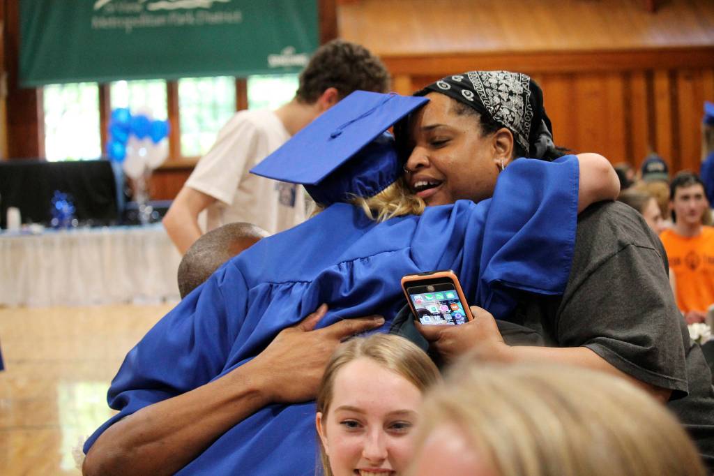 A students hugs their supporters during the Two Rivers School graduation ceremony. Photo courtesy of Two Rivers School