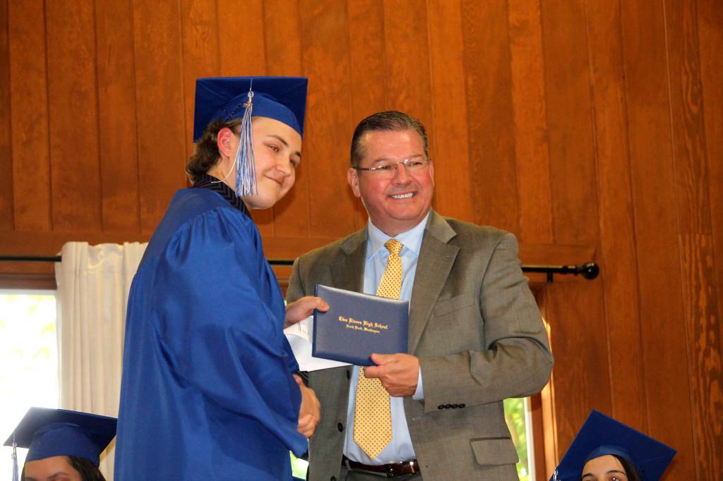 A Two Rivers School senior receives their diploma during the Two Rivers School graduation ceremony. Photo courtesy of Two Rivers School