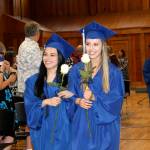 Two Rivers School students hold roses before the graduation ceremony. Photo courtesy of Two Rivers School