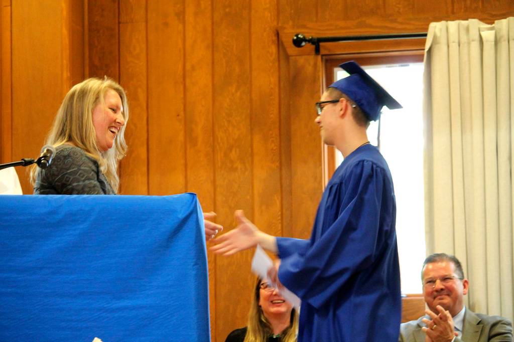 A Two Rivers School Student receives a scholarship award at the Two Rivers School graduation ceremony. Photo courtesy of Two Rivers School