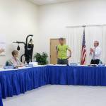Council and staff give Jeanne Petterson a standing ovation after she concludes her reading of the song I Must Be Going. Evan Pappas/Staff Photo