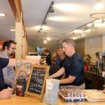 Attendees get some coffee at the grand opening event. Evan Pappas/Staff Photo