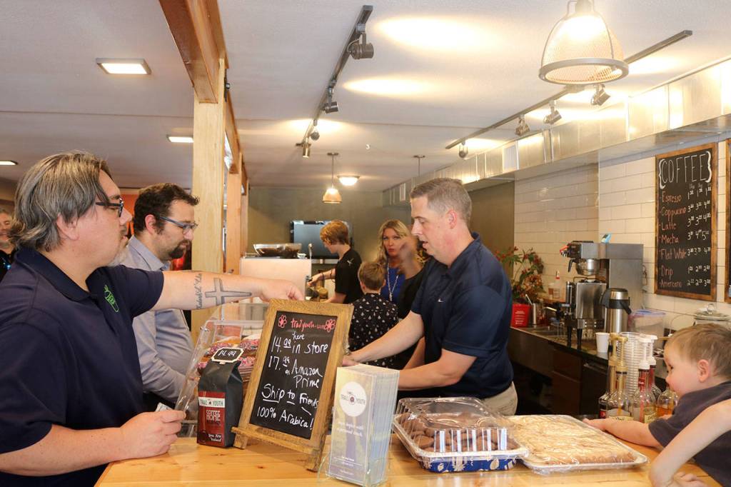 Attendees get some coffee at the grand opening event. Evan Pappas/Staff Photo