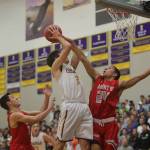 Mount Si Wildcats player Bijon Sidhu, right, tries to block a shot against Issaquah forward Will Farmer in a KingCo 4A contest between rivals on Jan. 5. The Wildcats finished the 2017-18 season with an overall record of 13-11.                                Photo courtesy of Don Borin/Stop Action Photography