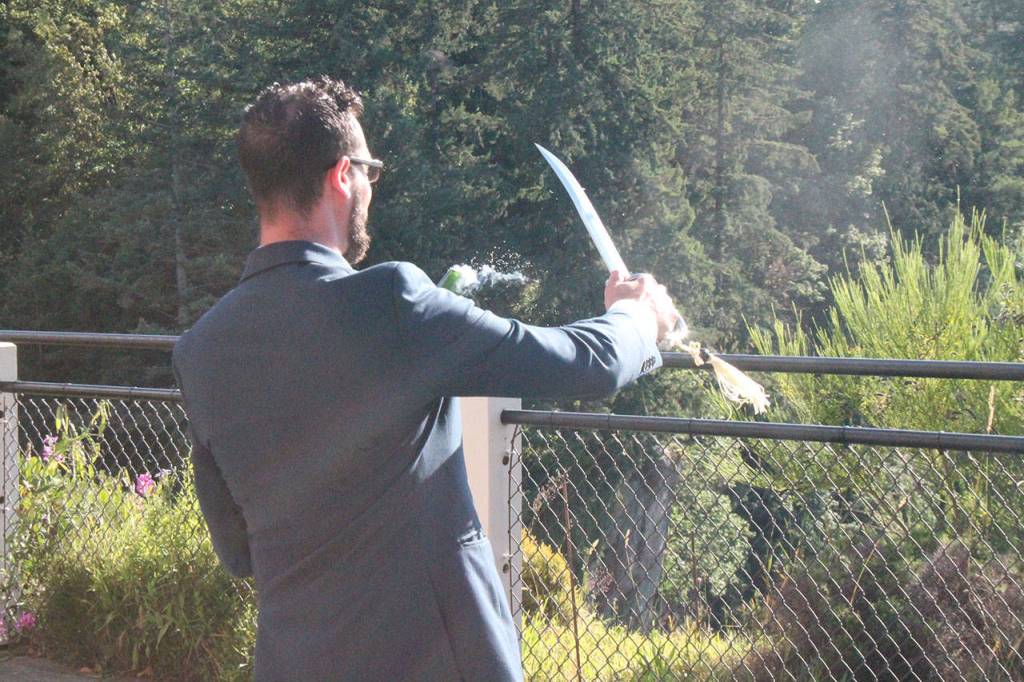 A bottle of champagne is opened with a saber at the Salish Lodge and Spas grand reopening following remodeling. The lodge overlooks Snoqualmie Falls. Aaron Kunkler/Staff photo