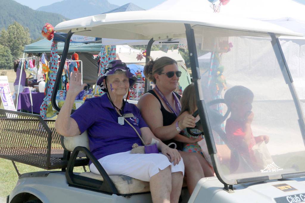 Bev Jorgensen makes the lap around Tollgate Farm Park, cheered on by friends and supporters. Evan Pappas/Staff Photo